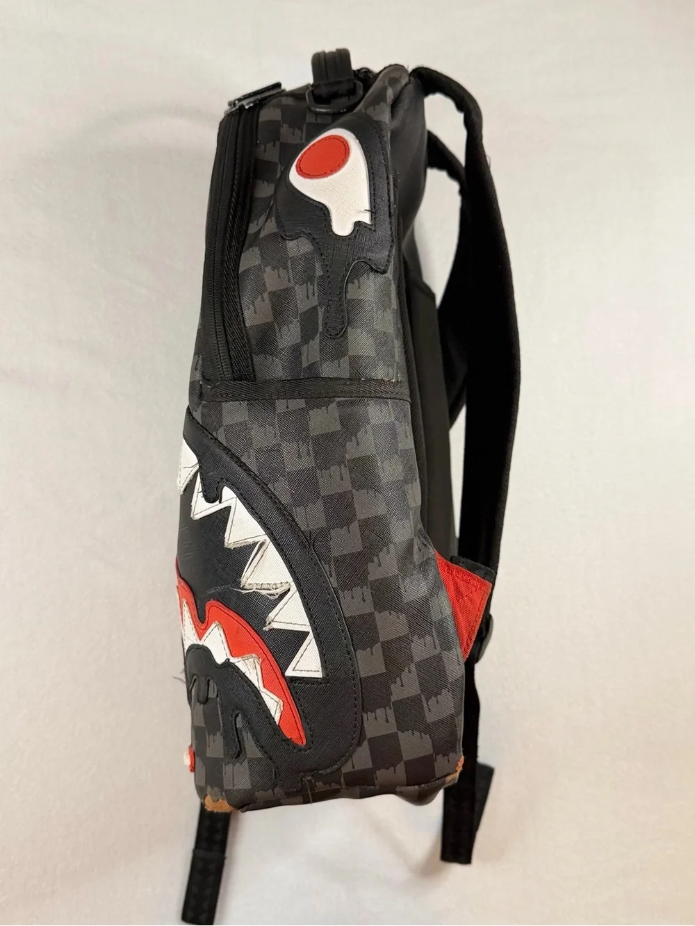 Sprayground Black Checkered Backpack with White and Red Shark Graphic